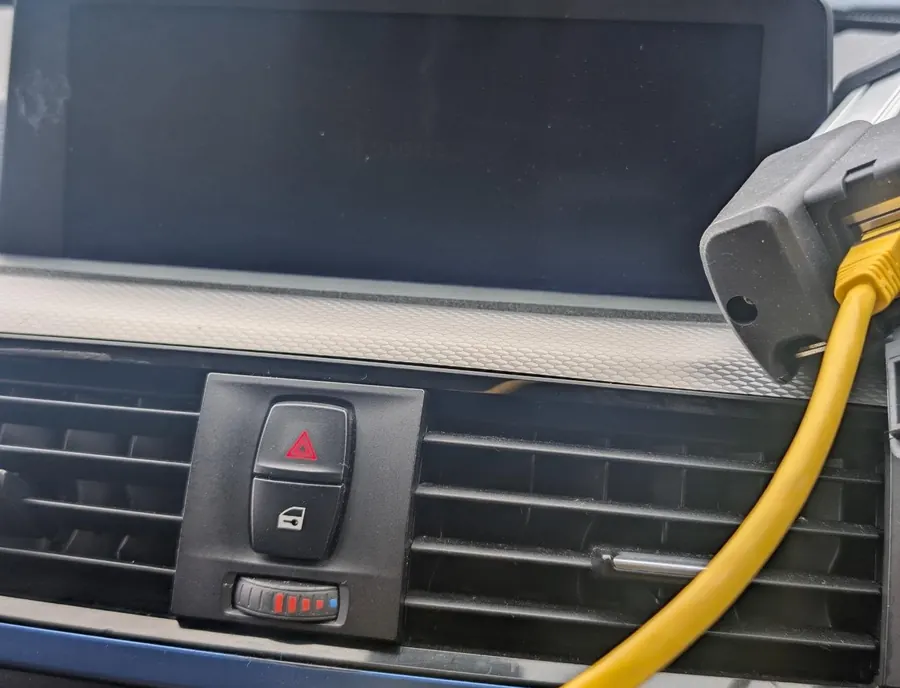 A cable connected at the dashboard of a BMW F30 during diagnostics