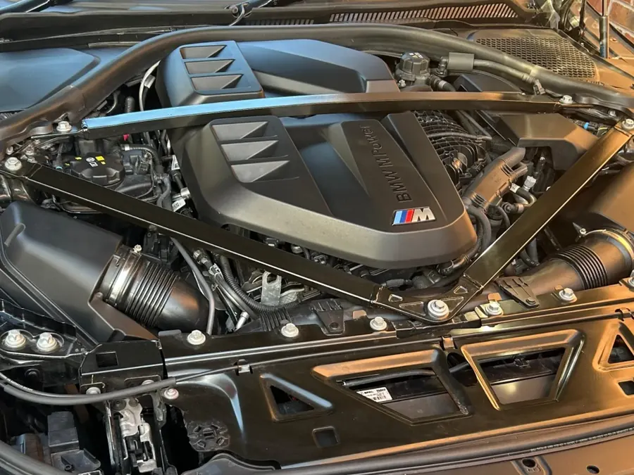 The engine bay of a black BMW G87 M2