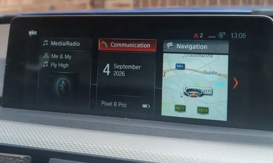 A BMW iDrive home screen with a phone connected